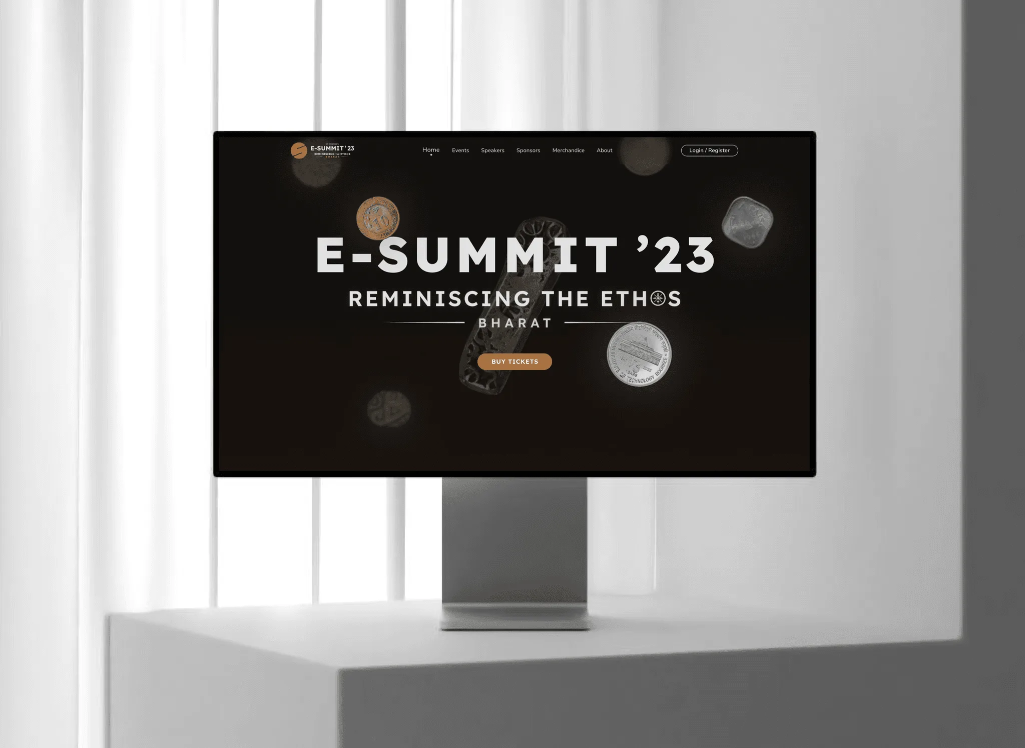 E-Summit '23 website hero reading Reminiscing the Ethos Bharat, with floating vintage coins, a navigation bar and a Buy Tickets button, on a desktop monitor