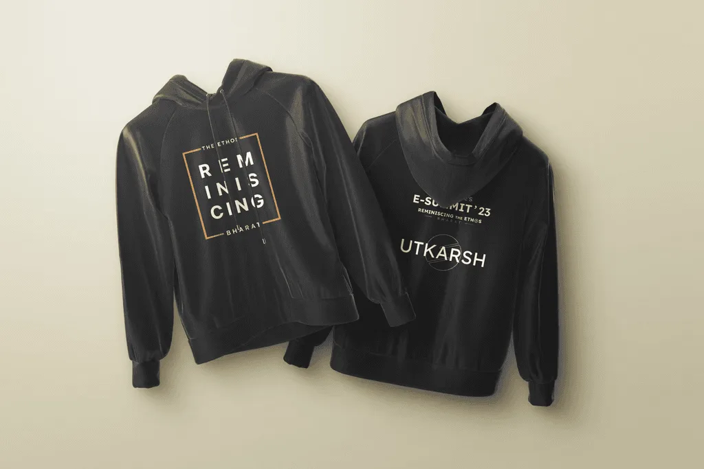 Two black E-Summit hoodies on a beige wall, one with a boxed Reminiscing type print on the front, one with the E-Summit '23 logo on the back
